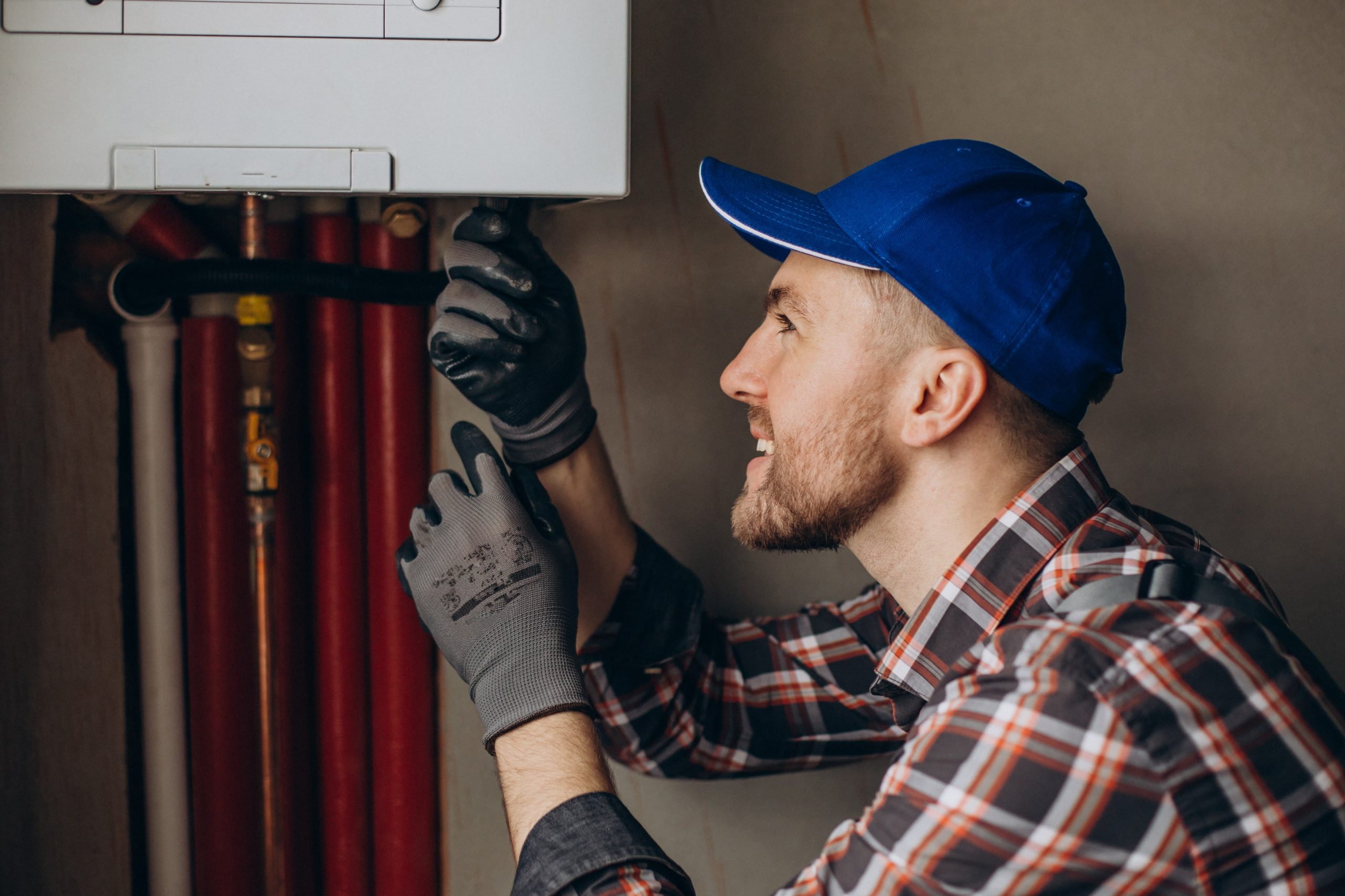 service-man-adjusting-house-heating-system-min